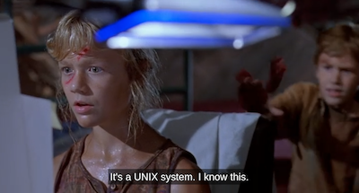 Screenshot of a scene from the film "Jurassic Park" where Lex is sitting at a computer saying "It's a unix system. I know this." while her little brother Tim watches.